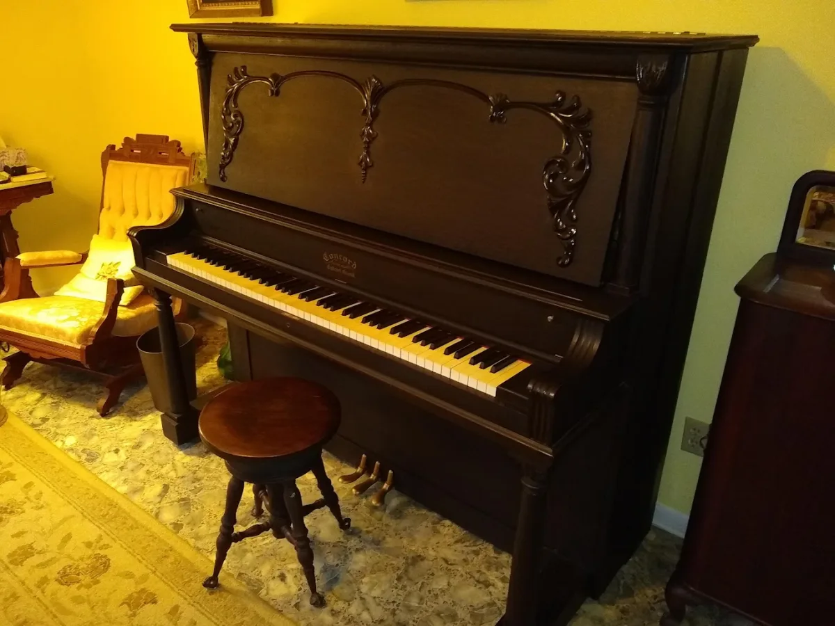 Antique Conrad upright piano in a period parlor