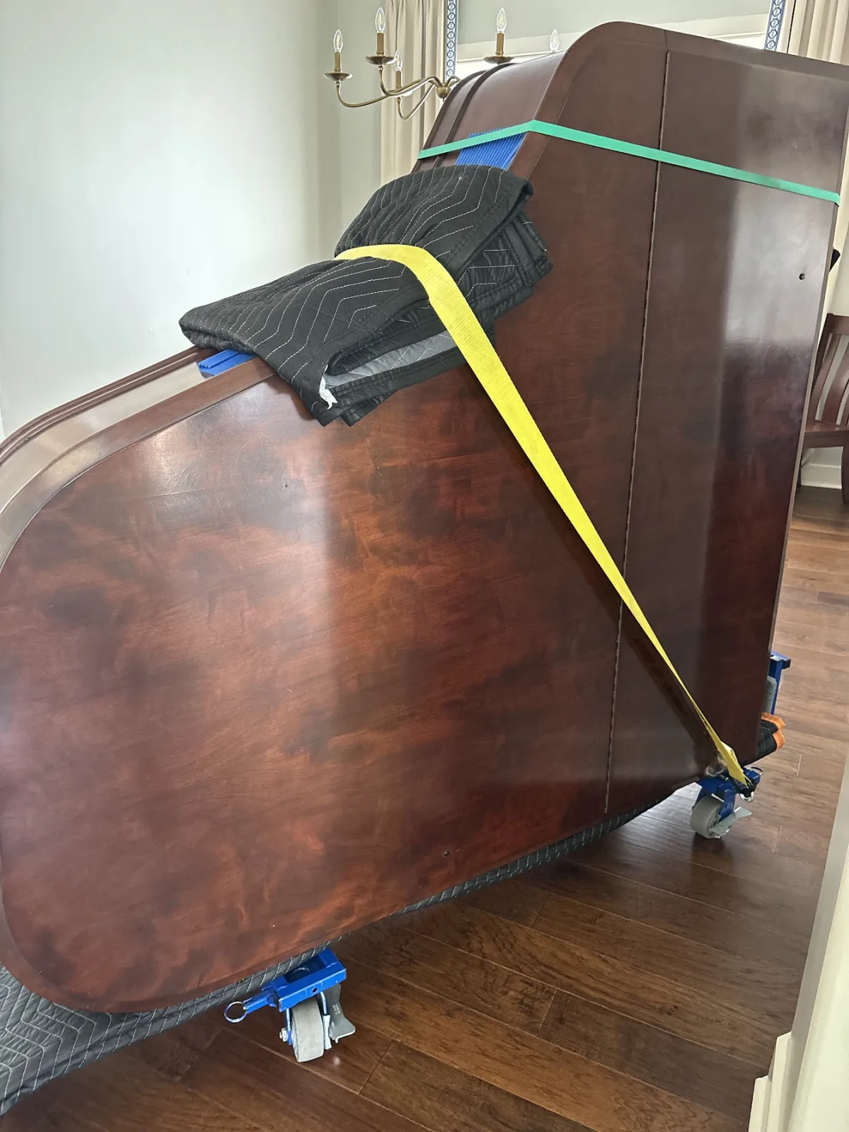 Grand piano secured on dolly during professional move